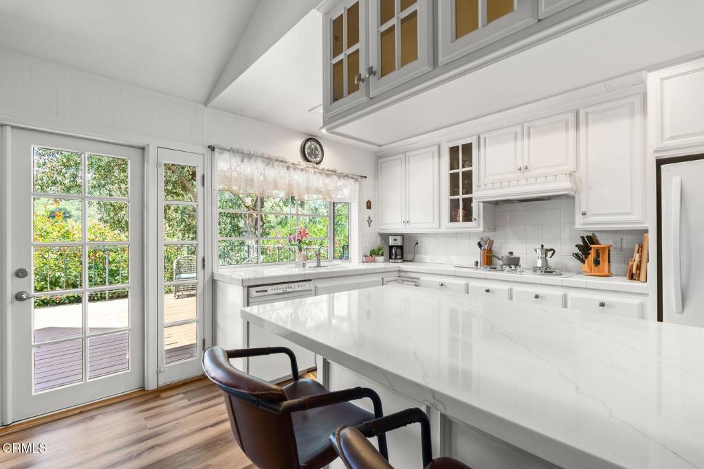 3907 United Road Agoura Hills, CA 91301 - Photo 10 of 34 a kitchen with stainless steel appliances granite countertop a stove a sink dishwasher and cabinets with wooden floor