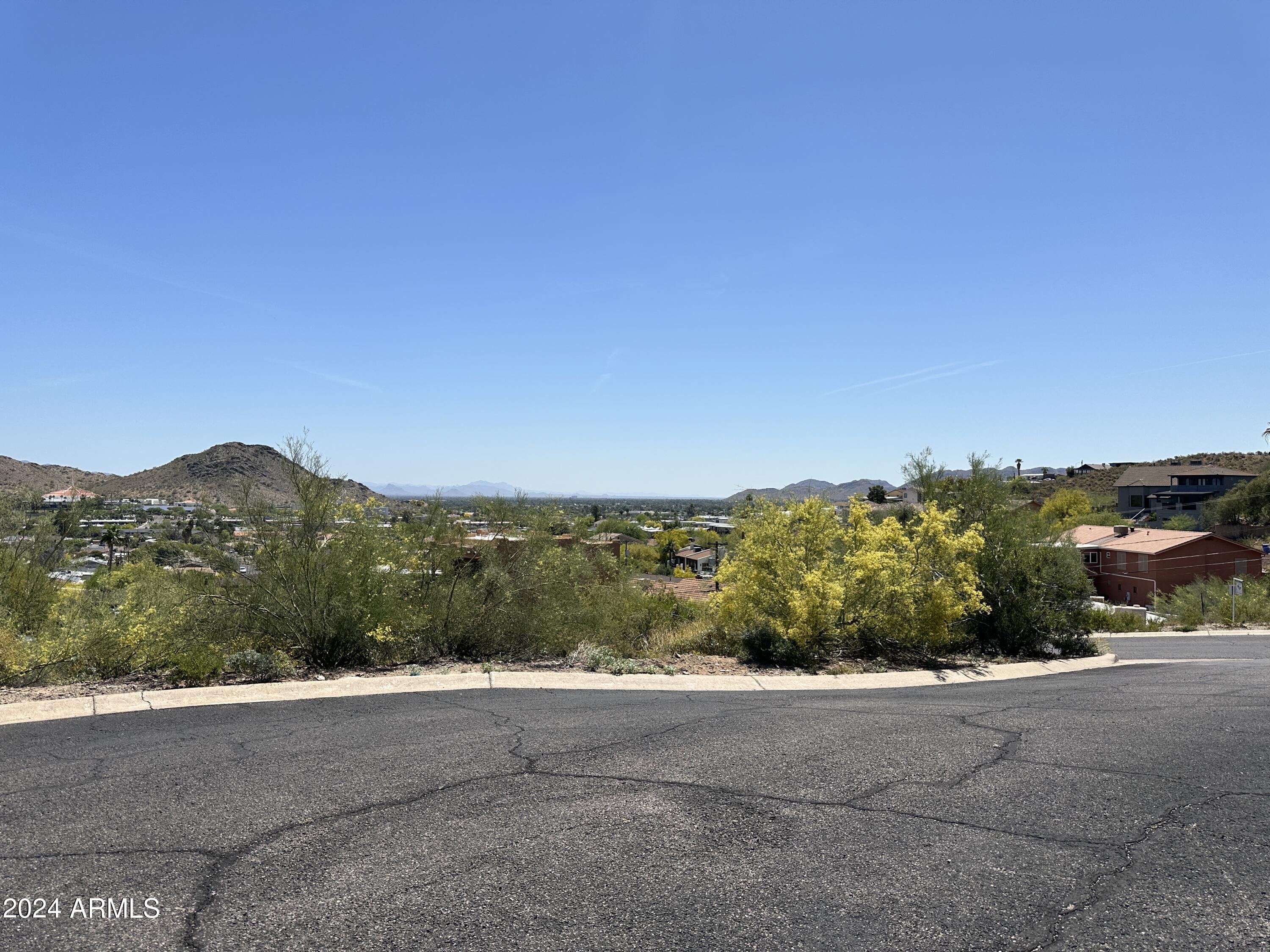 1702 East Calle Santa Cruz, Unit 29 Phoenix, AZ 85022 - Photo 15 of 15 a view of a road with a field