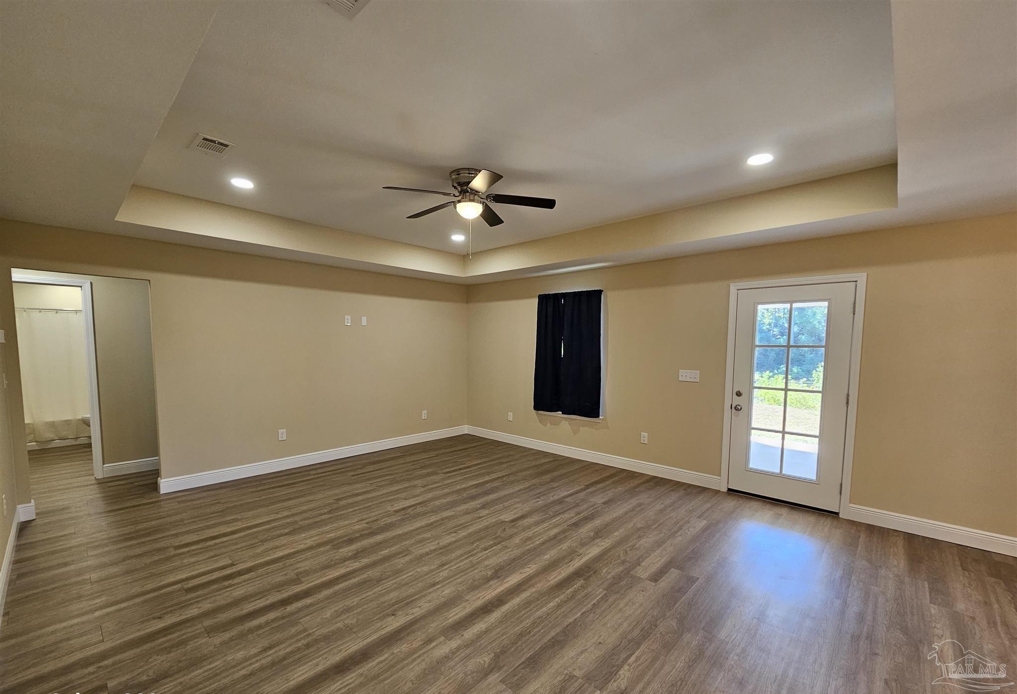 295 West Kingsfield Road Cantonment, FL 32533 - Photo 12 of 32 a view of an empty room with window and wooden floor
