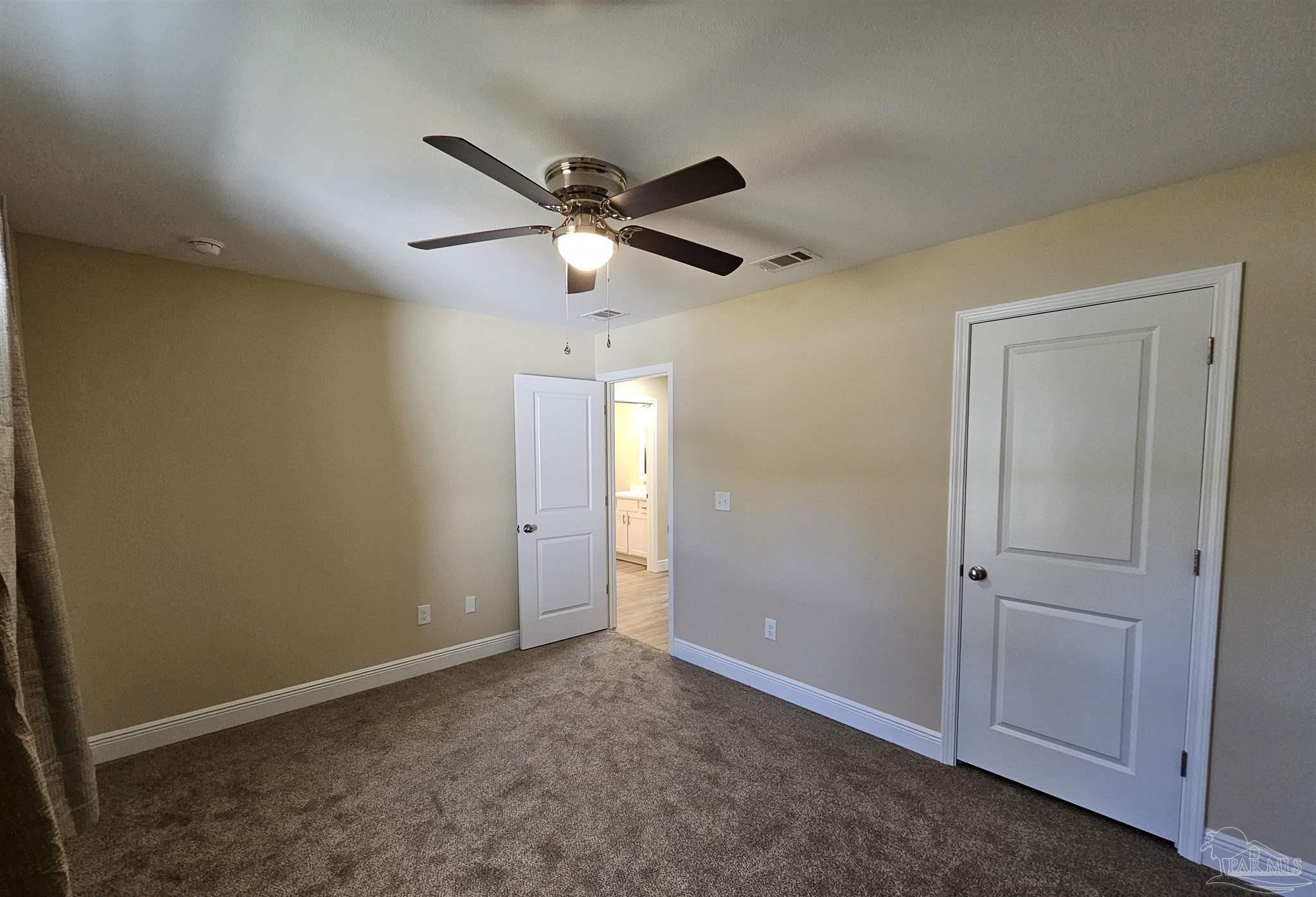 295 West Kingsfield Road Cantonment, FL 32533 - Photo 13 of 32 an empty room with closet and a ceiling fan