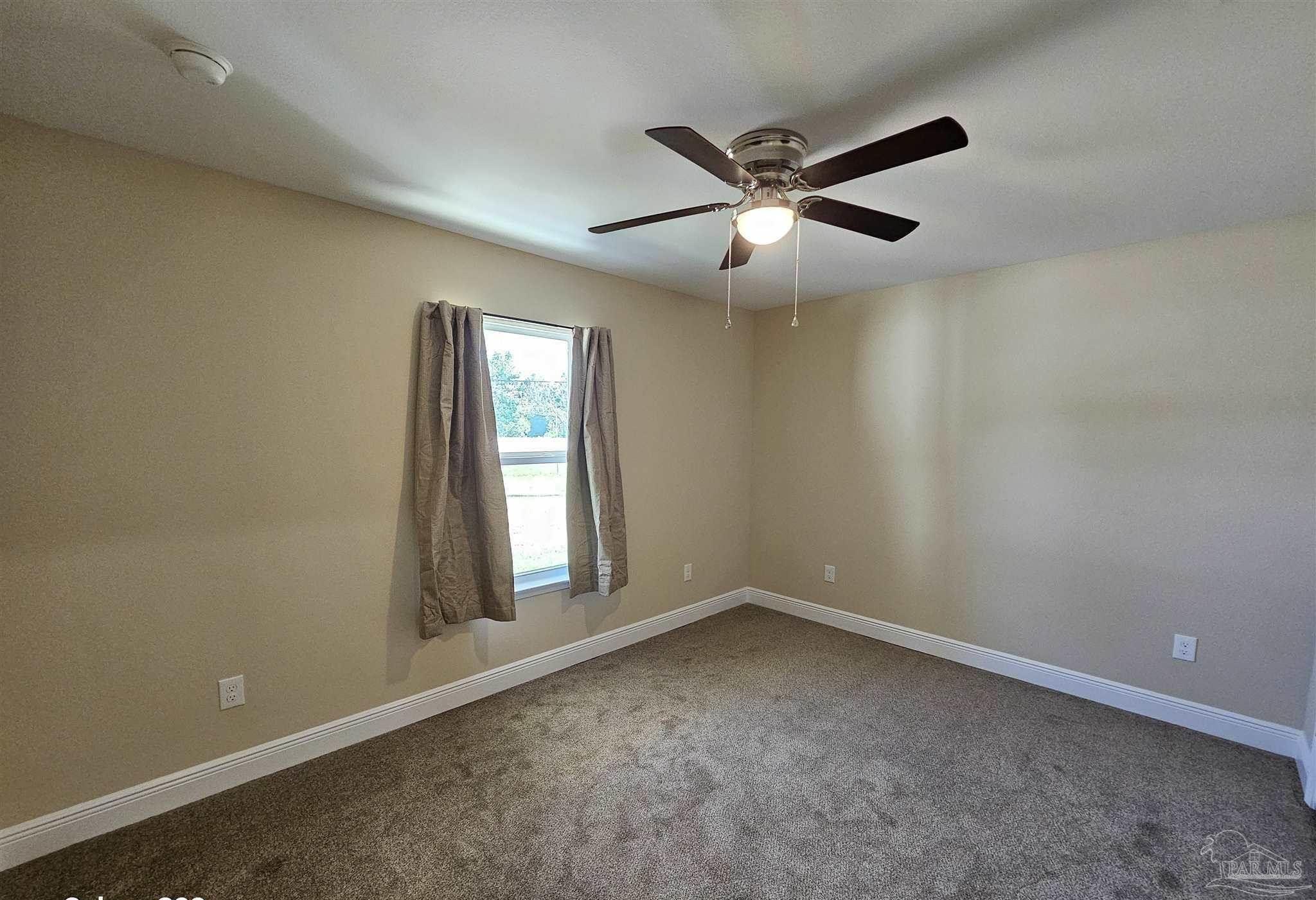 295 West Kingsfield Road Cantonment, FL 32533 - Photo 14 of 32 an empty room with a window and a fan