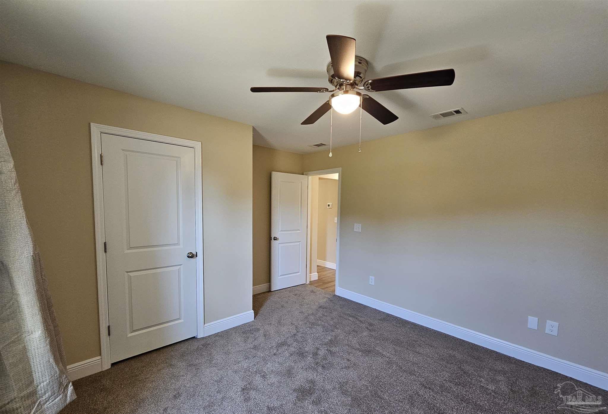 295 West Kingsfield Road Cantonment, FL 32533 - Photo 16 of 32 a view of a hallway with a ceiling fan and wooden floor