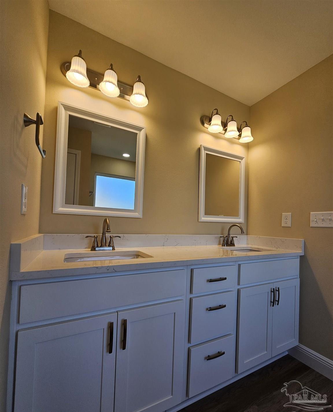 295 West Kingsfield Road Cantonment, FL 32533 - Photo 22 of 32 a bathroom with a double vanity sink and a mirror