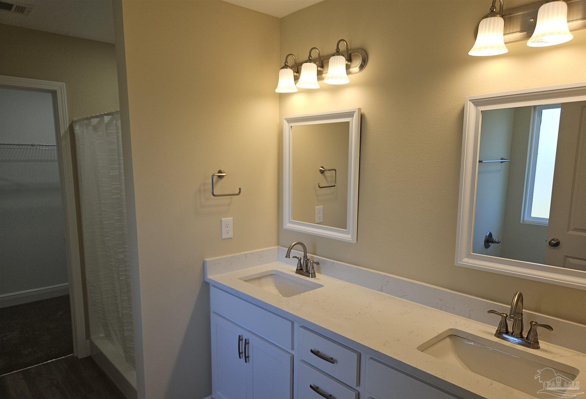 295 West Kingsfield Road Cantonment, FL 32533 - Photo 23 of 32 a bathroom with a sink and a mirror