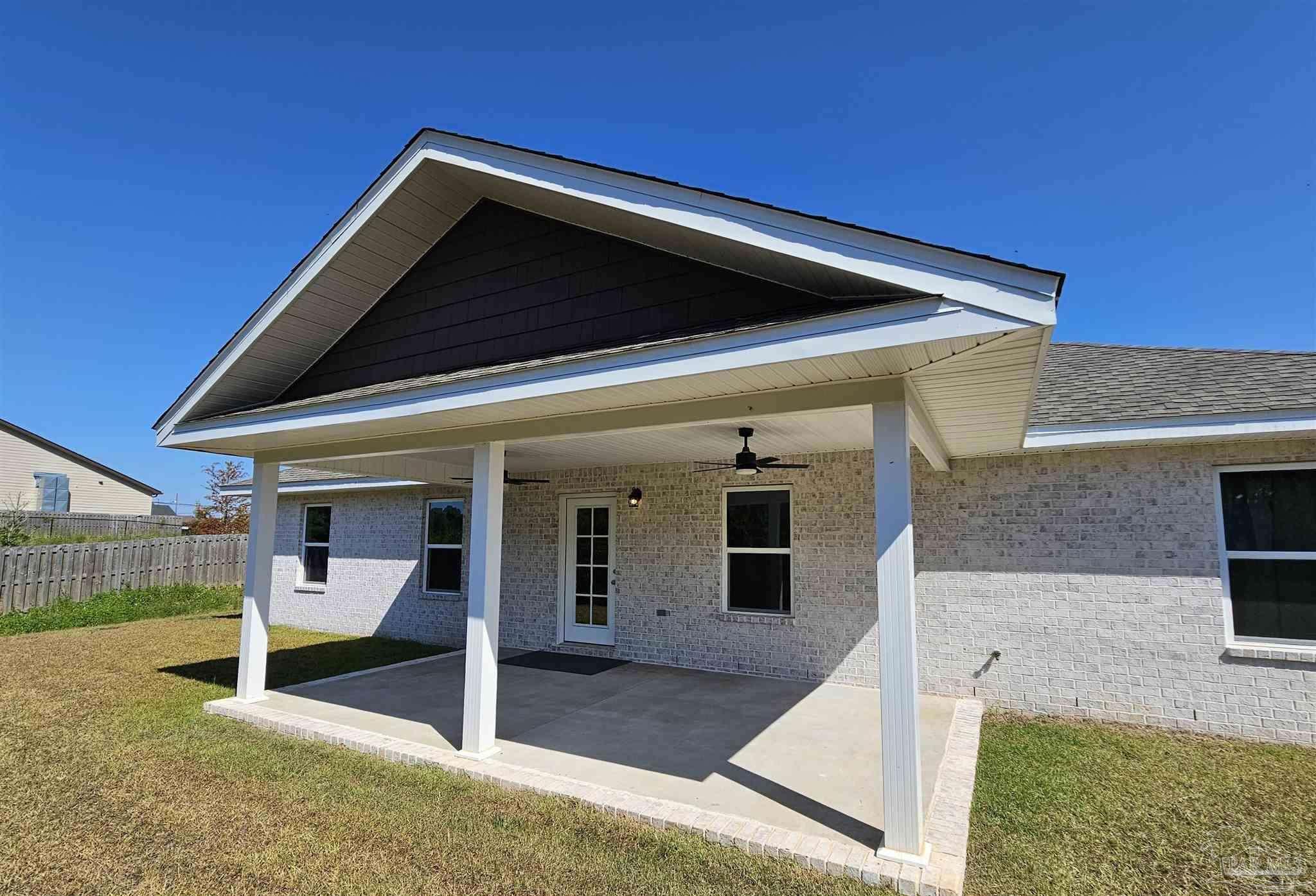 295 West Kingsfield Road Cantonment, FL 32533 - Photo 29 of 32 a view of an house with backyard porch and furniture