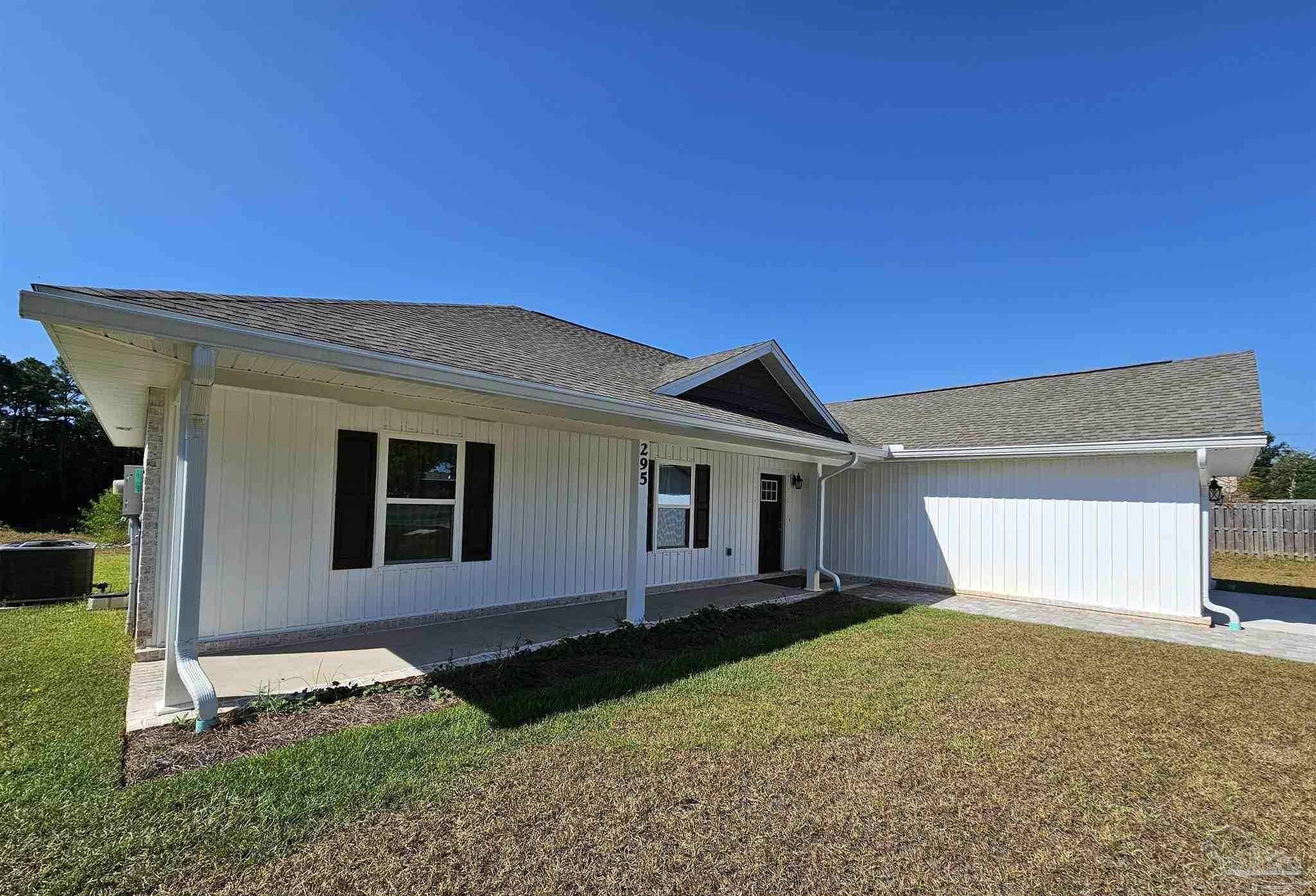 295 West Kingsfield Road Cantonment, FL 32533 - Photo 3 of 32 a front view of a house with a yard and garage