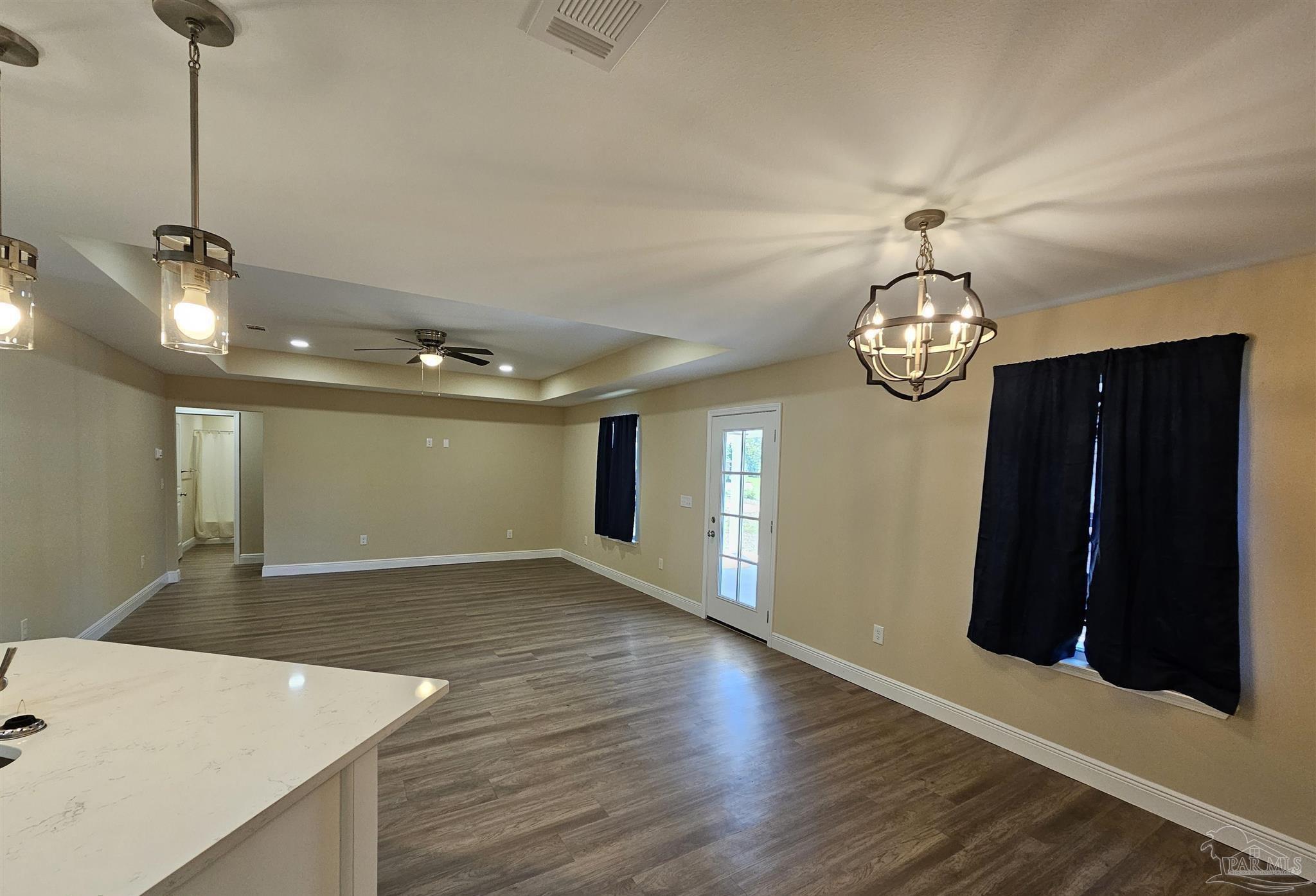 295 West Kingsfield Road Cantonment, FL 32533 - Photo 9 of 32 an empty room with wooden floor and windows
