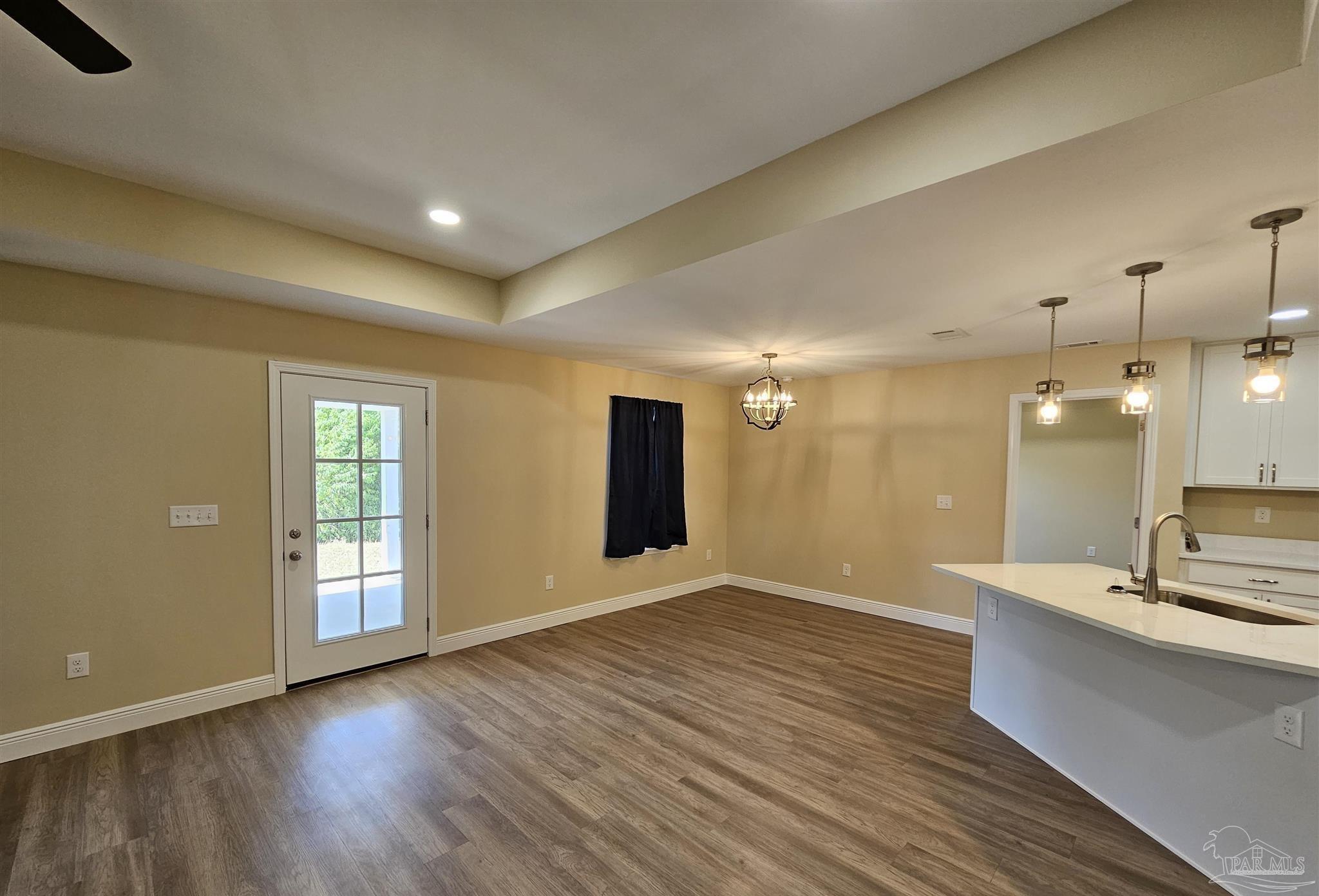 295 West Kingsfield Road Cantonment, FL 32533 - Photo 10 of 32 an empty room with wooden floor and windows