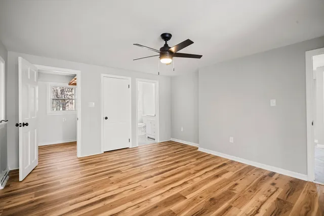a view of empty room with wooden floor