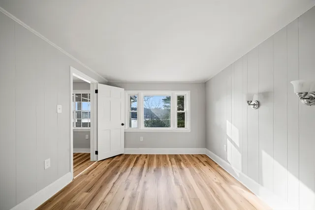 wooden floor in an empty room with a window