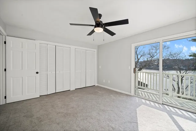 a view of a livingroom with a ceiling fan and window