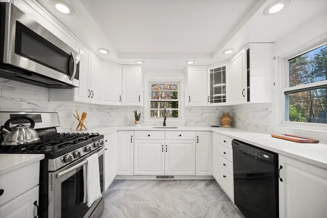 a kitchen with stainless steel appliances a sink stove and microwave