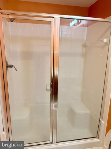 a bathroom with a glass shower door
