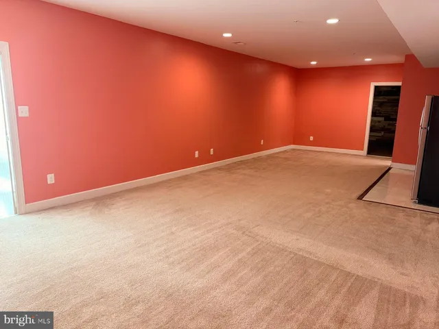 a view of an empty room with a fireplace