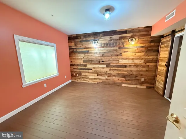 a view of room with window and wooden floor