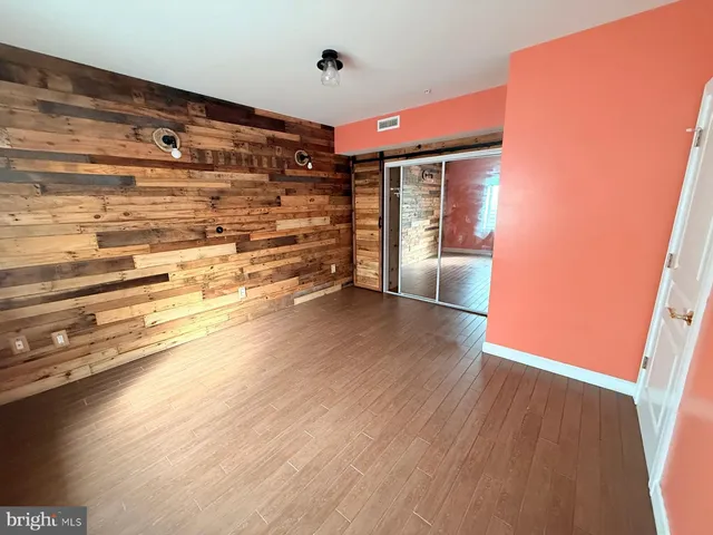 a view of an empty room and wooden floor
