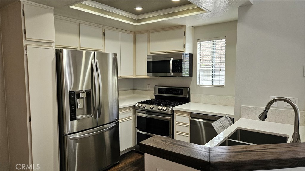 18922 Canyon Summit Lake Forest, CA 92679 - Photo 7 of 32 a kitchen with a refrigerator sink and microwave