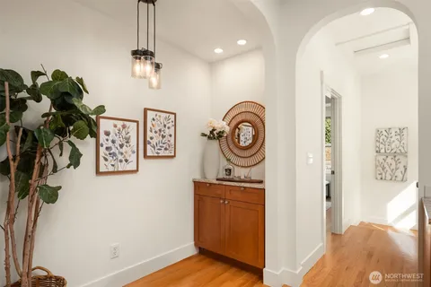 a view of a hallway with entryway wooden floor and front door