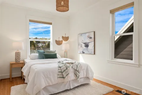 a bedroom with a bed and a painting on the wall