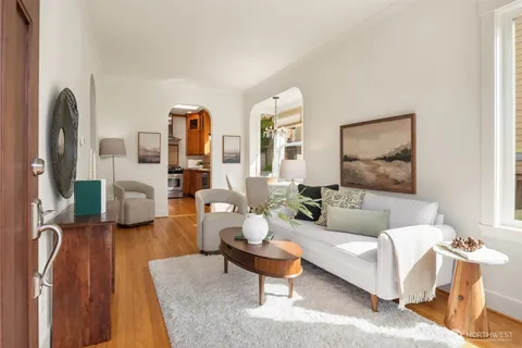 a living room with furniture and a lamp