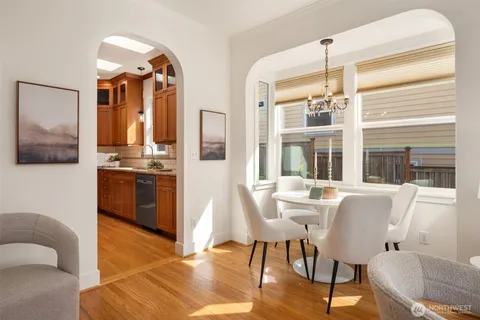 a view of a dining room with furniture and chandelier