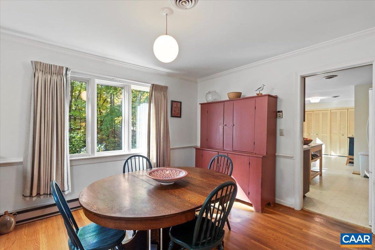 103 Vicar Court Charlottesville, VA 22901 - Photo 12 of 74 a kitchen with stainless steel appliances granite countertop a stove a refrigerator a dining table and chairs with wooden floor