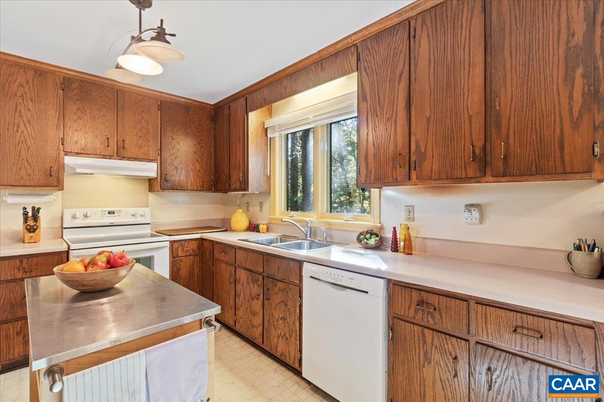 103 Vicar Court Charlottesville, VA 22901 - Photo 22 of 74 a kitchen with a sink dishwasher a stove and a refrigerator with wooden cabinets