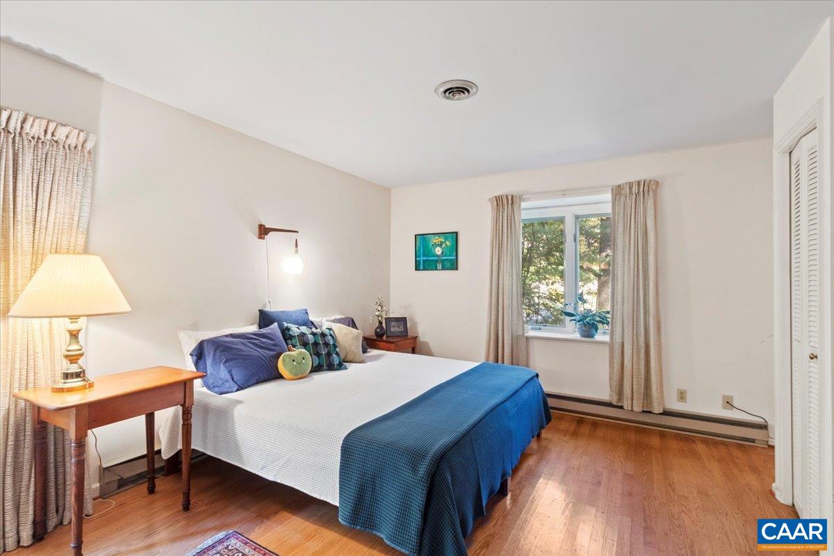 103 Vicar Court Charlottesville, VA 22901 - Photo 40 of 74 a bedroom with a bed and a lamp