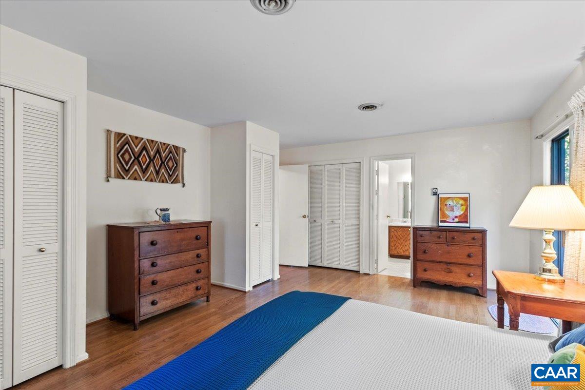 103 Vicar Court Charlottesville, VA 22901 - Photo 43 of 74 a bedroom with furniture and a wooden floor