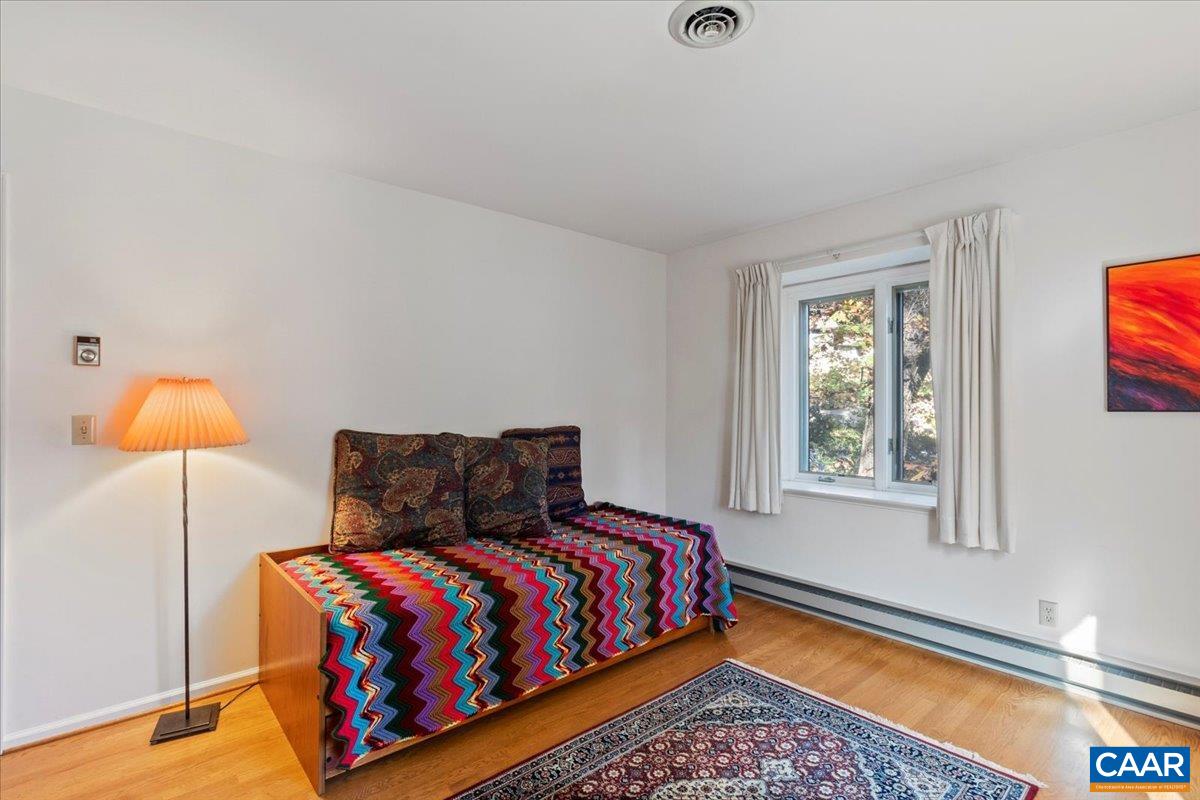 103 Vicar Court Charlottesville, VA 22901 - Photo 53 of 74 a bedroom with a bed and lamp