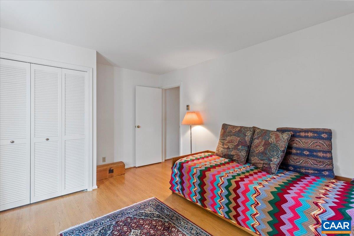 103 Vicar Court Charlottesville, VA 22901 - Photo 54 of 74 a bedroom with a bed and wooden floor