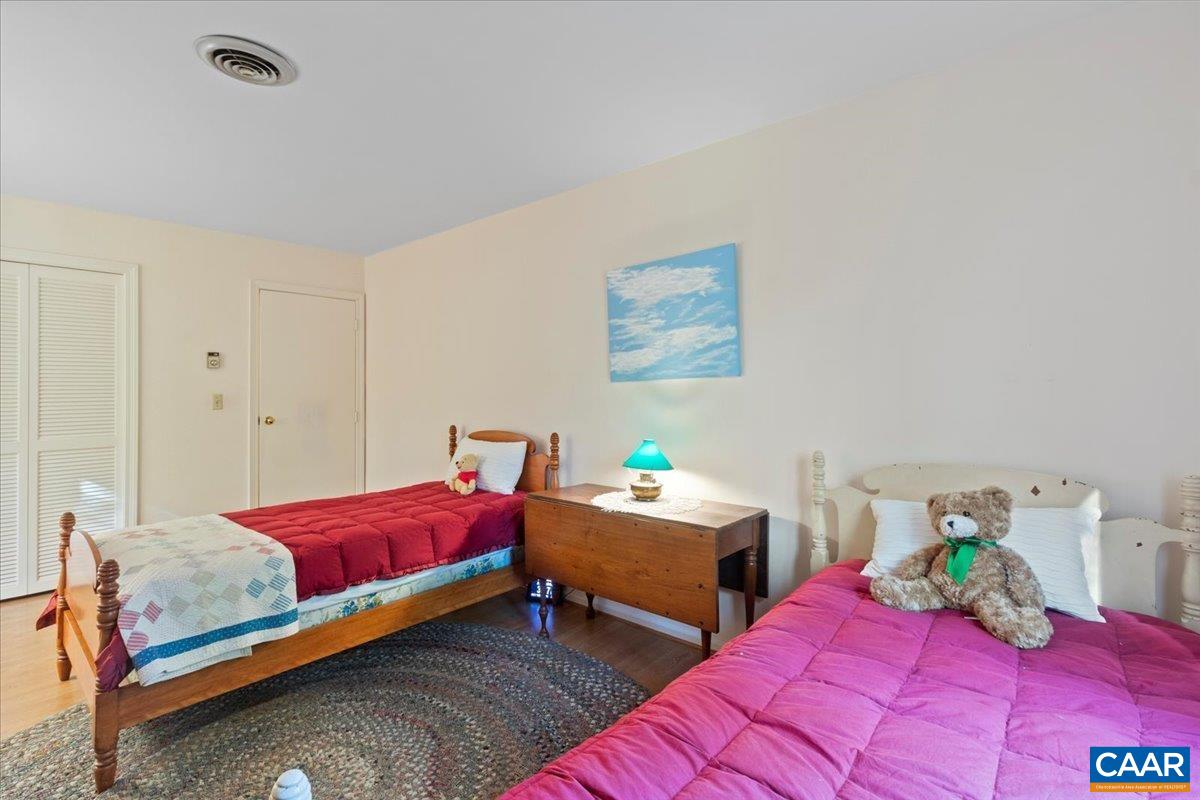 103 Vicar Court Charlottesville, VA 22901 - Photo 58 of 74 a bedroom with two beds and painting on the wall