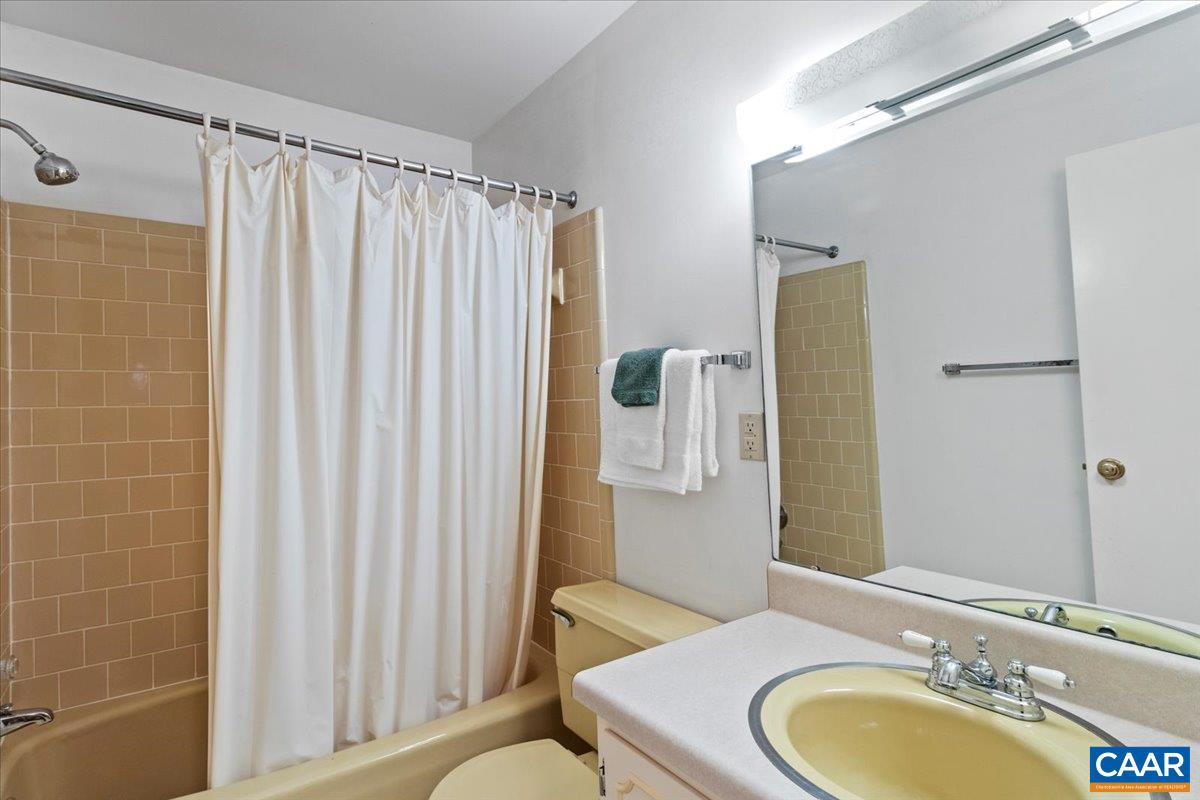 103 Vicar Court Charlottesville, VA 22901 - Photo 60 of 74 a bathroom with a granite countertop sink and a mirror