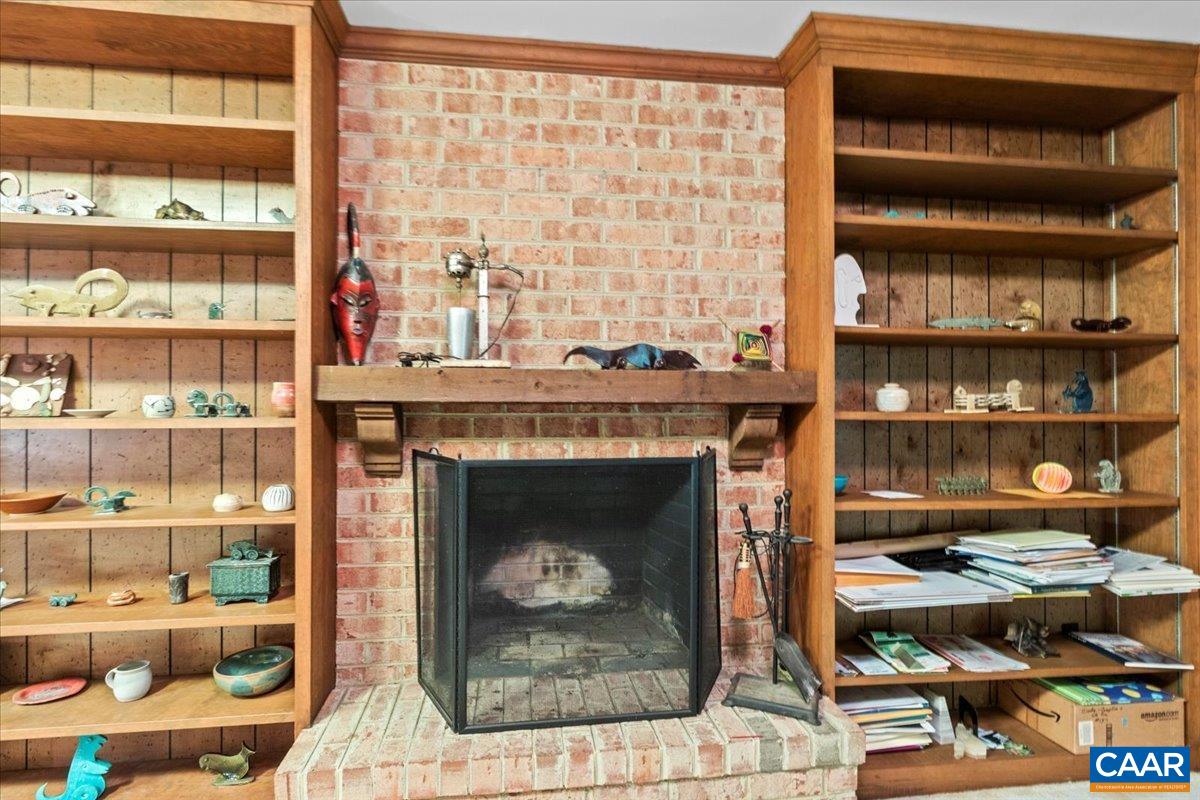 103 Vicar Court Charlottesville, VA 22901 - Photo 64 of 74 a living room with lots of books and a large window