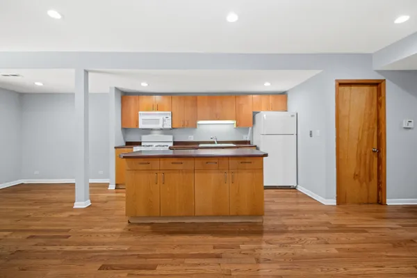 a kitchen with granite countertop a refrigerator and a stove