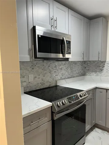 a kitchen with microwave cabinets and stainless steel appliances