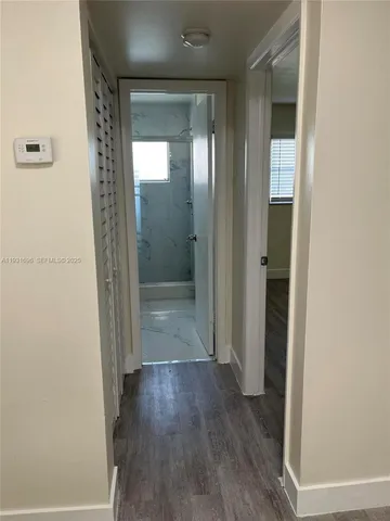 a bathroom with a glass door shower and a mirror