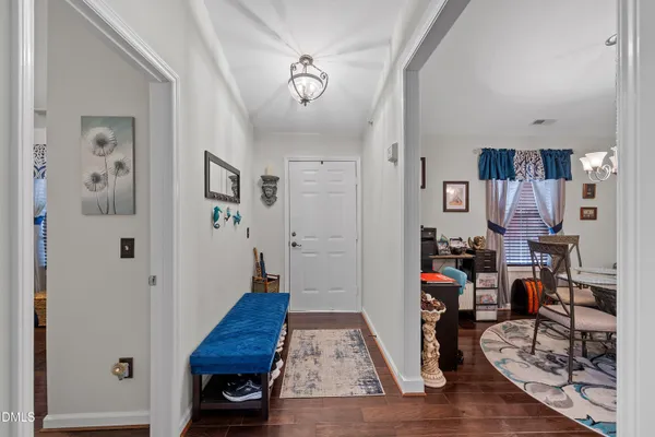 a view of a hallway with wooden floor and windows