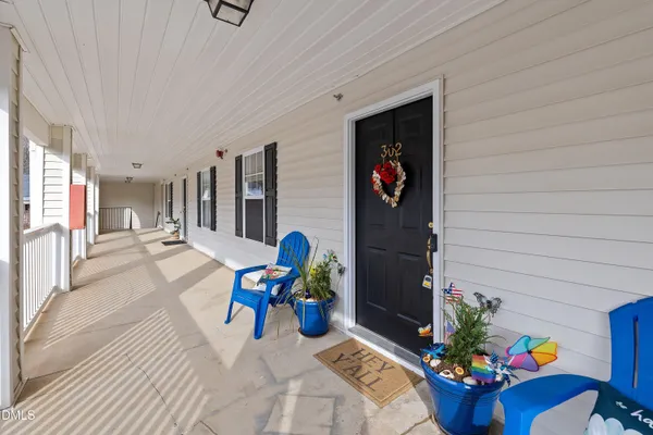 a view of living room filled with furniture and flowers