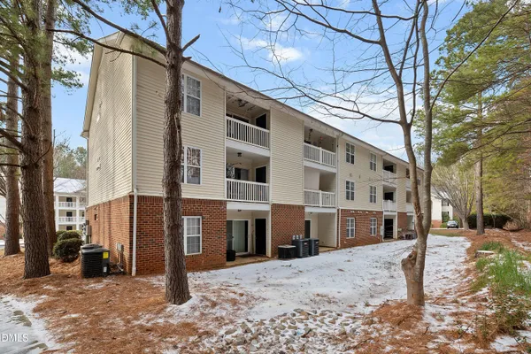 a view of a building with a snow on the road