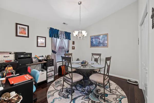 a dining room with furniture and wooden floor