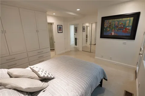a bed sitting in a bedroom next to a window