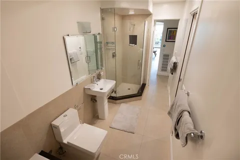 a bathroom with a double vanity sink a mirror and a bathtub