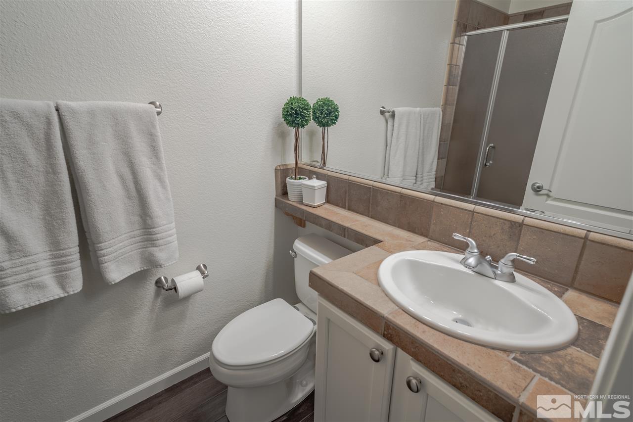 10590 Apple Mill Court Reno, NV 89521 - Photo 12 of 19 a bathroom with a sink toilet and a mirror