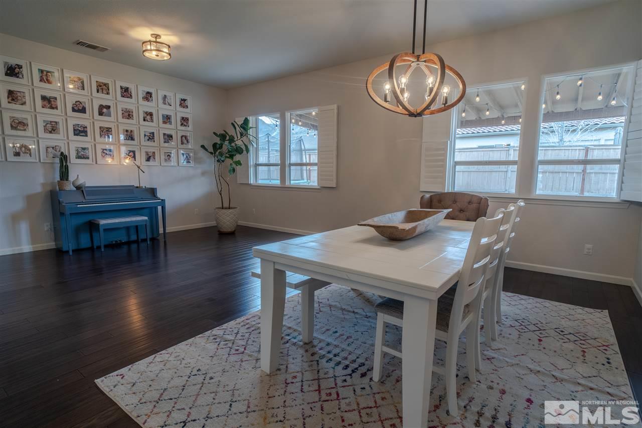 10590 Apple Mill Court Reno, NV 89521 - Photo 7 of 19 a view of a dining room with furniture wooden floor and chandelier