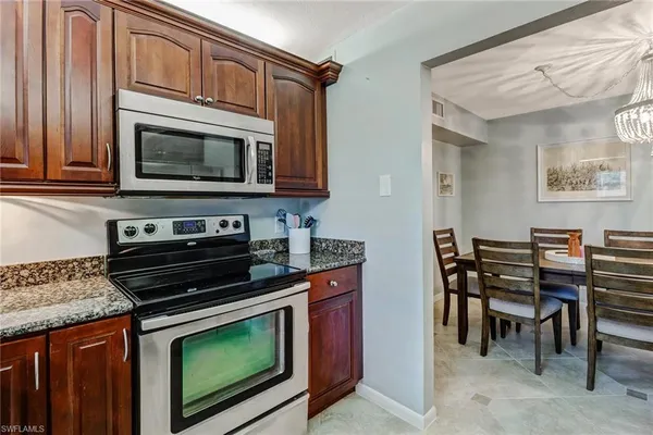 a kitchen with stainless steel appliances a stove sink and microwave