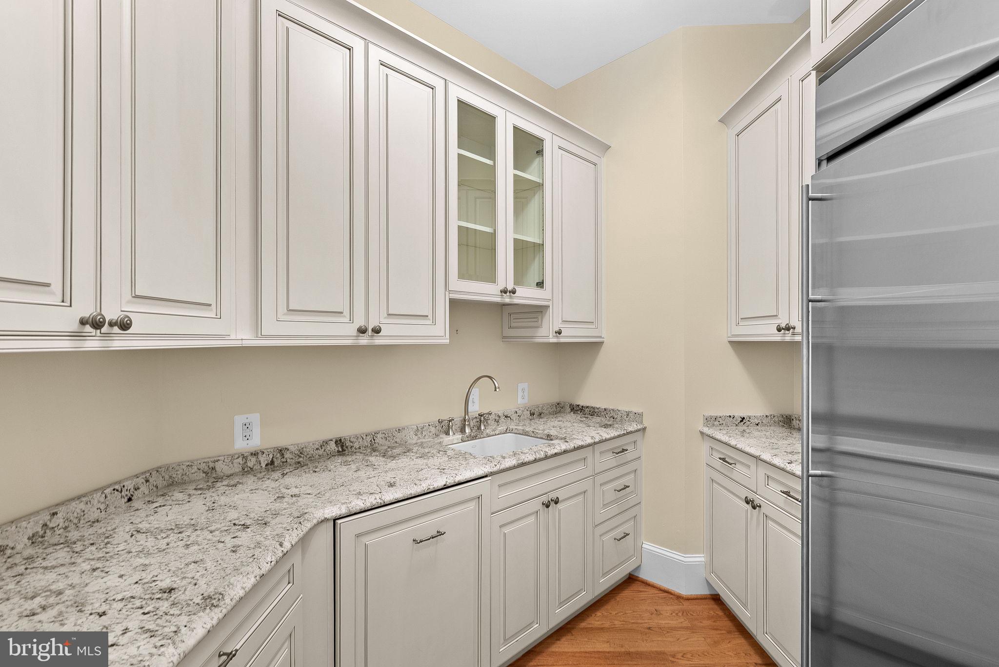 11913 Chapel Road Clifton, VA 20124 - Photo 37 of 124 a kitchen with granite countertop white cabinets and a sink
