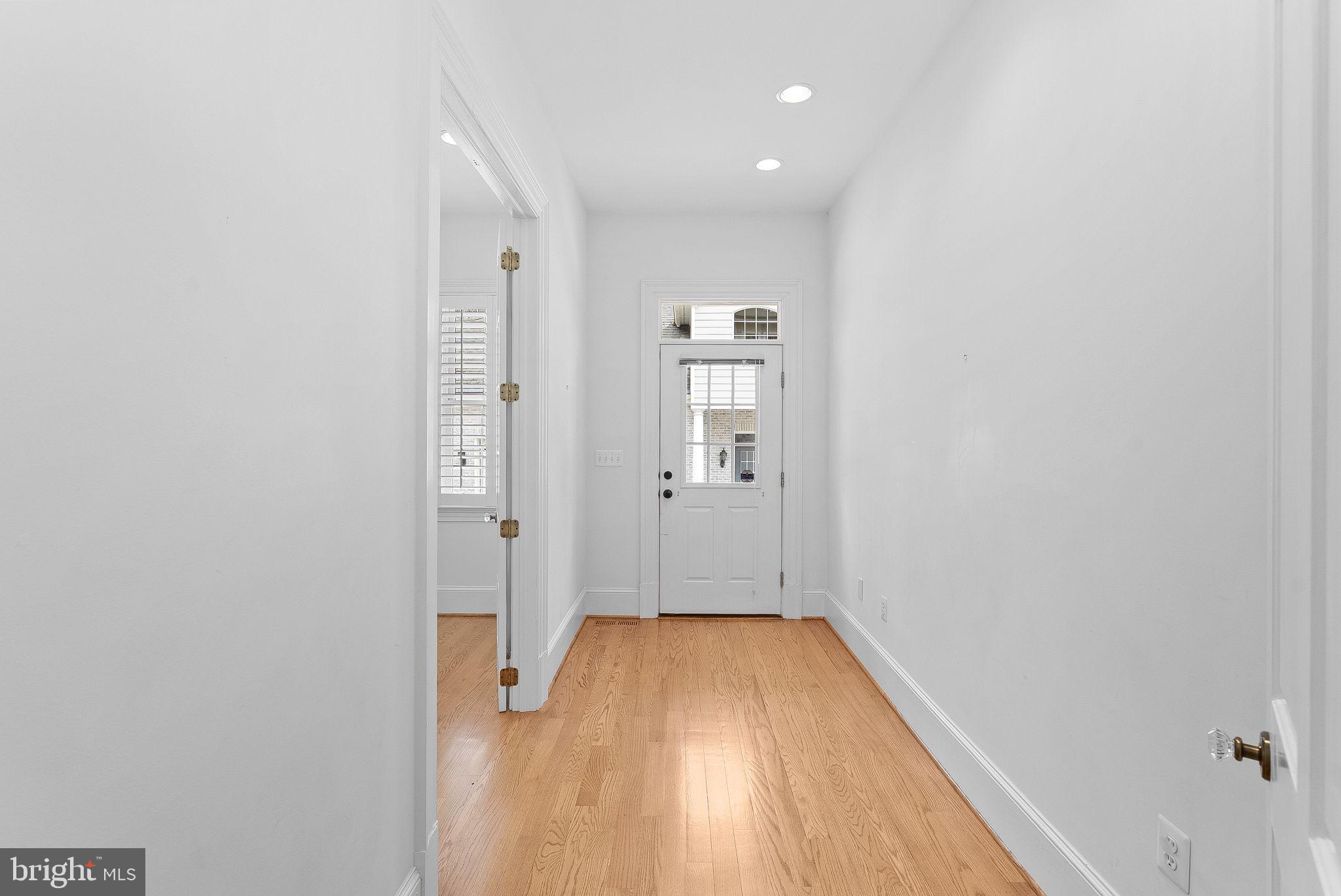 11913 Chapel Road Clifton, VA 20124 - Photo 38 of 124 a view of a hallway with wooden floor and a bathroom