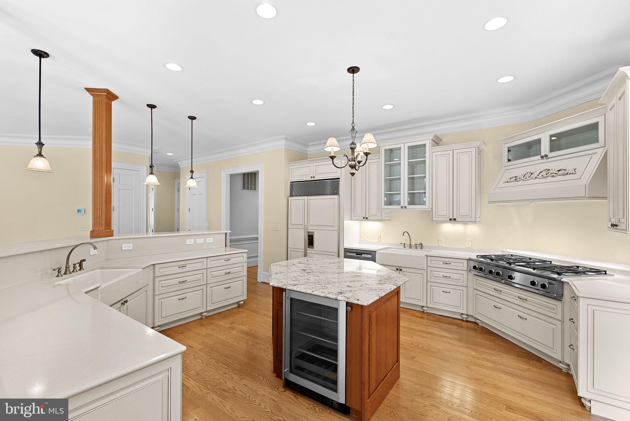 11913 Chapel Road Clifton, VA 20124 - Photo 41 of 124 a large kitchen with stainless steel appliances kitchen island granite countertop a stove a sink and white cabinets with wooden floor