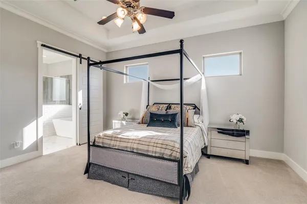 a bedroom with a bed and a chandelier